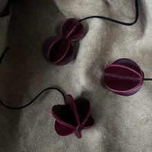 Load image into Gallery viewer, Set of six Christmas ornaments made from upcycled burgundy leather, featuring a trendy design and eco-friendly craftsmanship.