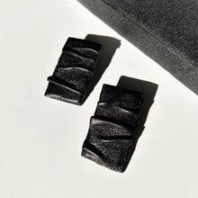 Load image into Gallery viewer, Close-up image of Ripple Stud Earrings E168. These earrings feature a textured, wave-like design that mimics ripples on water, crafted in shiny metallic finish. The studs are circular in shape and modest in size, suitable for both casual and formal wear.