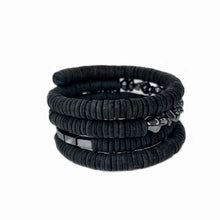 Load image into Gallery viewer, The "Continuous Coil Hematite Cuff" is a handcrafted bracelet featuring genuine leather sequins, meticulously hand-punched for a refined finish. It is adorned with two types of hematite gemstones, adding a touch of elegance and sophistication. The adjustable design ensures a perfect fit for any wrist size, while the soft, lightweight construction guarantees comfortable wear throughout the day. This cuff blends luxury and craftsmanship, making it a standout accessory for any occasion.