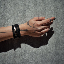 Load image into Gallery viewer, The "Continuous Coil Hematite Cuff" is a handcrafted bracelet featuring genuine leather sequins, meticulously hand-punched for a refined finish. It is adorned with two types of hematite gemstones, adding a touch of elegance and sophistication. The adjustable design ensures a perfect fit for any wrist size, while the soft, lightweight construction guarantees comfortable wear throughout the day. This cuff blends luxury and craftsmanship, making it a standout accessory for any occasion.