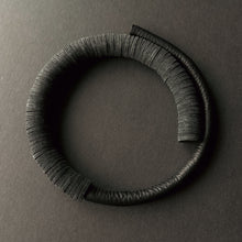 Load image into Gallery viewer, A close-up image of a Texture Fusion Leather Choker featuring a blend of leather textures, smooth hand-stitched tube and punched leather disks displayed against a neutral background