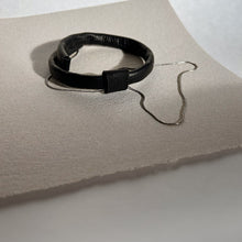 Load image into Gallery viewer, A close-up of an elegant leather choker featuring hand-stitched genuine leather and a high-quality stainless steel chain. The choker is adorned with a removable leather bead and is displayed against a neutral background.