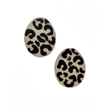 Load image into Gallery viewer, Handcrafted earrings made from smooth beige leather with a bold, hand-cut black leopard pattern, featuring a dynamic shape for a sleek and modern look. Lightweight and versatile, perfect for an edgy yet refined style.