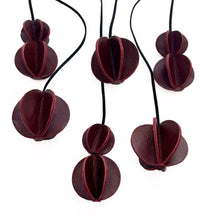 Load image into Gallery viewer, Set of six Christmas ornaments made from upcycled burgundy leather, featuring a trendy design and eco-friendly craftsmanship.