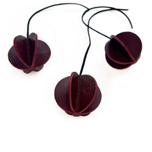 Load image into Gallery viewer, Set of six Christmas ornaments made from upcycled burgundy leather, featuring a trendy design and eco-friendly craftsmanship.