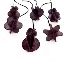 Load image into Gallery viewer, Set of six Christmas ornaments made from upcycled burgundy leather, featuring a trendy design and eco-friendly craftsmanship.