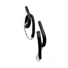 Load image into Gallery viewer, Close-up of Pearl Twist Earrings featuring twisted black leather loops paired with a strand of white pearls. The sculptural, lightweight design is bold and unusual, handcrafted from sustainable materials to create a modern statement piece."