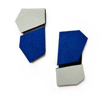 Load image into Gallery viewer,  Modern, handcrafted leather earrings with bold angular shapes in a mix of colors, bright blue and off-white, highlighting their lightweight yet statement-making design.
