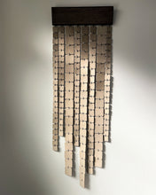 Load image into Gallery viewer, Minimalist wall hanging made of leather and wood, handcrafted and suspended, with freely hanging glossy leather strips catching light.