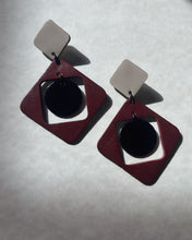 Load image into Gallery viewer, Statement leather earring in burgundy, beige, and black with layered geometric shapes and a shiny lacquered centerpiece.