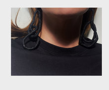 Load image into Gallery viewer, Crafted for bold style, these earrings feature a flexible wire wrapped in soft black leather, creating a unique design. With a long dangle-wrap style, they add drama to any outfit, while remaining lightweight for all-day comfort. The black leather wrapping adds texture and sophistication, offering an edgy yet elegant touch to your look.