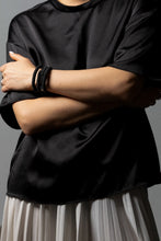 Load image into Gallery viewer, The "Continuous Coil Hematite Cuff" is a handcrafted bracelet featuring genuine leather sequins, meticulously hand-punched for a refined finish. It is adorned with two types of hematite gemstones, adding a touch of elegance and sophistication. The adjustable design ensures a perfect fit for any wrist size, while the soft, lightweight construction guarantees comfortable wear throughout the day. This cuff blends luxury and craftsmanship, making it a standout accessory for any occasion.