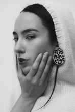 Load image into Gallery viewer, Handcrafted earrings made from smooth beige leather with a bold, hand-cut black leopard pattern, featuring a dynamic shape for a sleek and modern look. Lightweight and versatile, perfect for an edgy yet refined style.