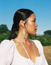 Load image into Gallery viewer, Revamp your classic dangle earrings with a modern minimalist twist. Our one-of-a-kind design features stacked sequins that create a bold yet muted impact. Enjoy the supreme softness and lightweight feel of these earrings as you move freely in their swing. The lengthening effect adds dimension and flatters your face. Don't miss out on this unique statement piece. Shop now for a pair of earrings that combine elegance with contemporary design.