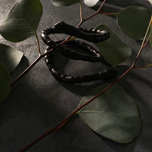 Load image into Gallery viewer, This genuine leather choker/bracelet hybrid lets you express your individuality and set your own standards of fashion. Wear it as a statement piece around your neck or wrist, or create customizable patterns for a unique look every time. Meticulously crafted with genuine leather wrapped around metal wire, this daring accessory is built to last. Be bold, be different, and let the Rebel Coil take your style to the next level.