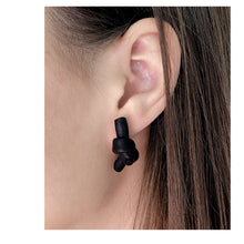 Load image into Gallery viewer, Handcrafted Leather knot stud earrings - a symbol of eternal connection and cherished bond. These earrings offer the perfect amount of visual interest for a flattering and pronounced presence, adding simple sophistication whether you're dressed up or down. The luxurious feel and suppleness of the fine leather is something to be admired, and the subtle colour-matched stitching reveals impeccable hand craftsmanship. Feel anchored with the knot and enjoy the timeless elegance of these earrings.