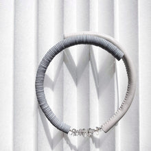 Load image into Gallery viewer, Our hand-stitched white leather choker with clear quartz crystals exudes both tranquility and edge. Adorn any outfit for a refined appearance or to give intention to your look. WAIWAI chokers are the softest, lightest, and most comfortable you'll ever wear. Shop now and elevate your look with comfort and style.