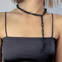 Load image into Gallery viewer, Elevate your jewelry collection with this unique hand-stitched leather chain from WAIWAI. The innovative design features leather links of different lengths and strategically-placed clasps, allowing for multiple styling options. The soft texture and visible grain of the high-quality leather make for a luxurious and comfortable wear. Lightweight and versatile, this chain adds a powerful sense of connectedness to any outfit.
