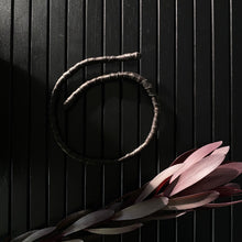 Load image into Gallery viewer, This genuine leather choker/bracelet hybrid lets you express your individuality and set your own standards of fashion. Wear it as a statement piece around your neck or wrist, or create customizable patterns for a unique look every time. Meticulously crafted with genuine leather wrapped around metal wire, this daring accessory is built to last. Be bold, be different, and let the Rebel Coil take your style to the next level.