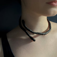 Load image into Gallery viewer, This genuine leather choker/bracelet hybrid lets you express your individuality and set your own standards of fashion. Wear it as a statement piece around your neck or wrist, or create customizable patterns for a unique look every time. Meticulously crafted with genuine leather wrapped around metal wire, this daring accessory is built to last. Be bold, be different, and let the Rebel Coil take your style to the next level.