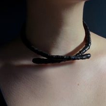 Load image into Gallery viewer, This genuine leather choker/bracelet hybrid lets you express your individuality and set your own standards of fashion. Wear it as a statement piece around your neck or wrist, or create customizable patterns for a unique look every time. Meticulously crafted with genuine leather wrapped around metal wire, this daring accessory is built to last. Be bold, be different, and let the Rebel Coil take your style to the next level.