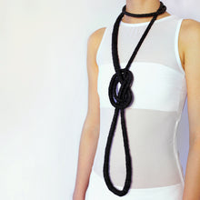 Load image into Gallery viewer, Elevate your style with our bold and modern extra-long necklace. Crafted with genuine leather disks ranging from 6-14mm and cotton waxed cord, it's a true statement piece that challenges the ideals of traditional accessories. Wear it as is or get creative by draping it around your waist or creating a crossed pattern. This disruptor of a necklace is sure to turn heads and start conversations. Shop now for a minimalistic yet eye-catching addition to your high-fashion wardrobe.