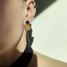 Load image into Gallery viewer, Effortlessly chic minimalist earrings in earthy tones. Basic shapes & delicate leather grain add subtle character. Suspended circles symbolize wholeness & promote a state of calm. Perfect for modernizing any outfit.