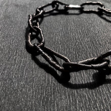 Load image into Gallery viewer, The contemporary design features flexible links that can be molded to create a serene or expressive look, adding a hint of deviance to a classic piece. The luxurious leather-wrapped links make it timeless and forever relevant. Chains symbolize our connections to others, the earth, and ourselves, making this necklace not only fashionable but also meaningful. Get creative with your styling and showcase the attractive closure. Don't miss out on this must-have accessory.