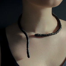 Load image into Gallery viewer, This genuine leather choker/bracelet hybrid lets you express your individuality and set your own standards of fashion. Wear it as a statement piece around your neck or wrist, or create customizable patterns for a unique look every time. Meticulously crafted with genuine leather wrapped around metal wire, this daring accessory is built to last. Be bold, be different, and let the Rebel Coil take your style to the next level.