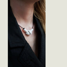 Load image into Gallery viewer, Elevate your style with a leather knot pendant necklace - a symbol of eternal connection and cherished bonds. With modern sophistication and impeccable hand craftsmanship, this necklace showcases the fine qualities of leather. Available in two lengths, it's functional art with a meaning, making it the perfect gift for yourself or a loved one. Choose the shorter length for a flattering collarbone accent or the longer length to wear over your heart.