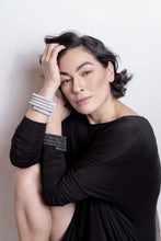 Load image into Gallery viewer, Elevate your style with this statement cuff bracelet that symbolizes growth, resilience, and strength. Made with individually hand-punched genuine leather sequins and stainless steel memory wire, this cuff is soft, lightweight, and comfortable for all-day wear. Adjust the diameter to your wrist size or stretch out the length to your imagination. Make a bold fashion statement with this unique and eye-catching accessory.