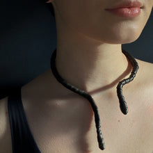 Load image into Gallery viewer, This genuine leather choker/bracelet hybrid lets you express your individuality and set your own standards of fashion. Wear it as a statement piece around your neck or wrist, or create customizable patterns for a unique look every time. Meticulously crafted with genuine leather wrapped around metal wire, this daring accessory is built to last. Be bold, be different, and let the Rebel Coil take your style to the next level.