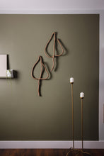 Load image into Gallery viewer, Handmade upcycled leather wall decor accent in the shape of a leaf, featuring a minimalist design with natural textures. Soft, lightweight and eco-friendly, this elegant piece adds a touch of sophistication to any room. Perfect for those who appreciate high-end design, it is an affordable luxury item that is easy to hang on any wall. A sustainable choice that showcases your commitment to eco-conscious living.