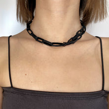 Load image into Gallery viewer, Elevate your jewelry collection with this unique hand-stitched leather chain from WAIWAI. The innovative design features leather links of different lengths and strategically-placed clasps, allowing for multiple styling options. The soft texture and visible grain of the high-quality leather make for a luxurious and comfortable wear. Lightweight and versatile, this chain adds a powerful sense of connectedness to any outfit.