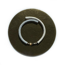 Load image into Gallery viewer, Our hand-stitched white leather choker with pyrite crystals embodies empowerment anchored by serenity. Pyrite deflects negative energy and promotes physical healing and mental strength. Complement any outfit with this choker that is soft, comfortable, and easy to wear. Shop now and feel empowered both inside and out.