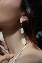Load image into Gallery viewer, Looking for a bold and empowering accessory? Look no further than these crisp white leather and pyrite earrings. The raw metallic lustre of pyrite adds a touch of mystery and provides protection from negative energy while promoting physical healing and emotional strength. Perfect for any occasion, these earrings embody the harmonized contrasts of life and empower you to feel radiant and serene like a modern goddess.