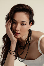 Load image into Gallery viewer, Elevate your jewelry collection with this unique hand-stitched leather chain from WAIWAI. The innovative design features leather links of different lengths and strategically-placed clasps, allowing for multiple styling options. The soft texture and visible grain of the high-quality leather make for a luxurious and comfortable wear. Lightweight and versatile, this chain adds a powerful sense of connectedness to any outfit.