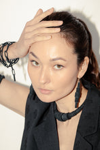 Load image into Gallery viewer, Elevate your jewelry collection with this unique hand-stitched leather chain from WAIWAI. The innovative design features leather links of different lengths and strategically-placed clasps, allowing for multiple styling options. The soft texture and visible grain of the high-quality leather make for a luxurious and comfortable wear. Lightweight and versatile, this chain adds a powerful sense of connectedness to any outfit.
