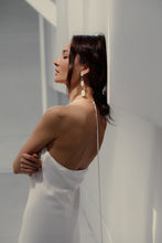 Load image into Gallery viewer, Looking for a bold and empowering accessory? Look no further than these crisp white leather and pyrite earrings. The raw metallic lustre of pyrite adds a touch of mystery and provides protection from negative energy while promoting physical healing and emotional strength. Perfect for any occasion, these earrings embody the harmonized contrasts of life and empower you to feel radiant and serene like a modern goddess.