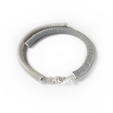 Load image into Gallery viewer, Our hand-stitched white leather choker with clear quartz crystals exudes both tranquility and edge. Adorn any outfit for a refined appearance or to give intention to your look. WAIWAI chokers are the softest, lightest, and most comfortable you'll ever wear. Shop now and elevate your look with comfort and style.