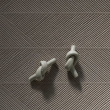 Load image into Gallery viewer, Handcrafted Leather knot stud earrings - a symbol of eternal connection and cherished bond. These earrings offer the perfect amount of visual interest for a flattering and pronounced presence, adding simple sophistication whether you're dressed up or down. The luxurious feel and suppleness of the fine leather is something to be admired, and the subtle colour-matched stitching reveals impeccable hand craftsmanship. Feel anchored with the knot and enjoy the timeless elegance of these earrings.
