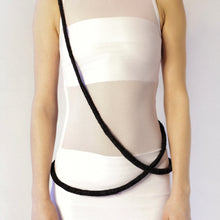 Load image into Gallery viewer, Elevate your style with our bold and modern extra-long necklace. Crafted with genuine leather disks ranging from 6-14mm and cotton waxed cord, it's a true statement piece that challenges the ideals of traditional accessories. Wear it as is or get creative by draping it around your waist or creating a crossed pattern. This disruptor of a necklace is sure to turn heads and start conversations. Shop now for a minimalistic yet eye-catching addition to your high-fashion wardrobe.