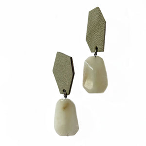 Leather earrings adorned with mesmerizing white jade stones that evoke tranquility and purity. The white jade is known for its calming properties and spiritual significance, adding timeless elegance to the design