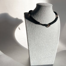 Load image into Gallery viewer, Handcrafted necklace featuring black leather discs, glossy obsidian stones, and translucent smoky quartz gemstones, designed with a bold and modern aesthetic.