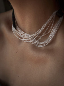 Model wearing black leather and clear glass bead choker, sculptural interlocking necklace by WAIWAI