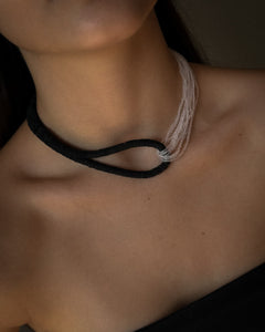 Model wearing black leather and clear glass bead choker, sculptural interlocking necklace by WAIWAI