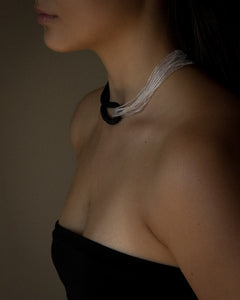 Model wearing black leather and clear glass bead choker, sculptural interlocking necklace by WAIWAI
