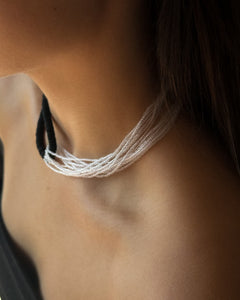 Model wearing black leather and clear glass bead choker, sculptural interlocking necklace by WAIWAI
