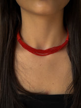 Load image into Gallery viewer, A choker that pairs hand-stitched leather with cascading strands of glass beads. The tubular leather form gives it presence, while the beads add fluid movement in a striking red. Lightweight and adjustable, made for moments that stand out.