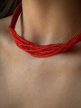 Load image into Gallery viewer, A choker that pairs hand-stitched leather with cascading strands of glass beads. The tubular leather form gives it presence, while the beads add fluid movement in a striking red. Lightweight and adjustable, made for moments that stand out.